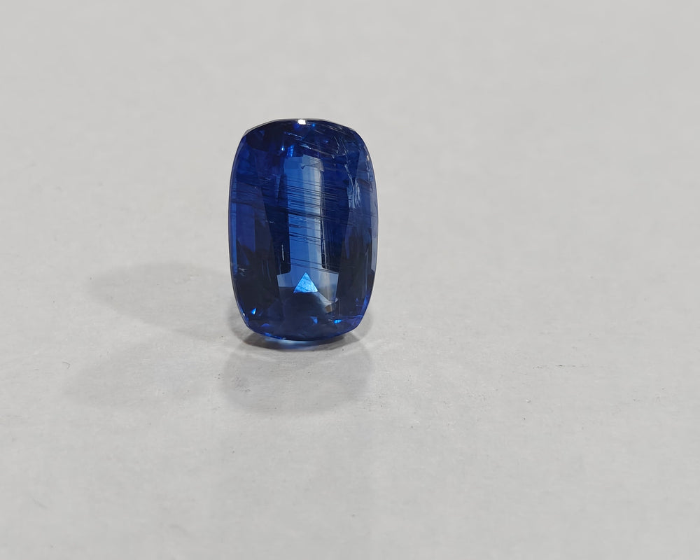 Blue gemstone on a light gray background