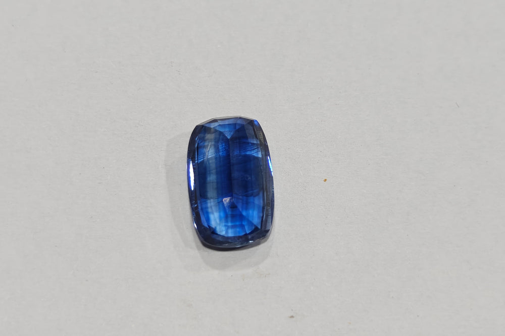 Blue gemstone on a light gray background